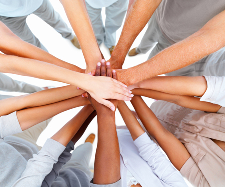 Multi-Ethnic hands on top of each other in a circle