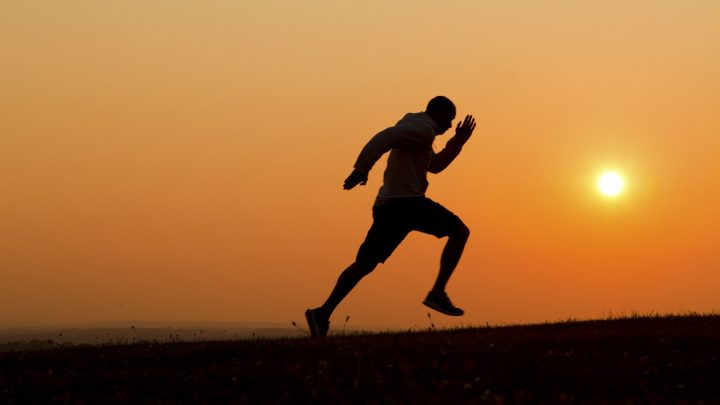 Man Running Uphill into the Sunset